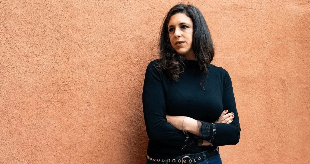 Ariana Harwicz sobre una pared naranja